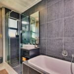 A sleek and stylish bathroom design featuring a bathtub and glass shower in Pretoria, South Africa.