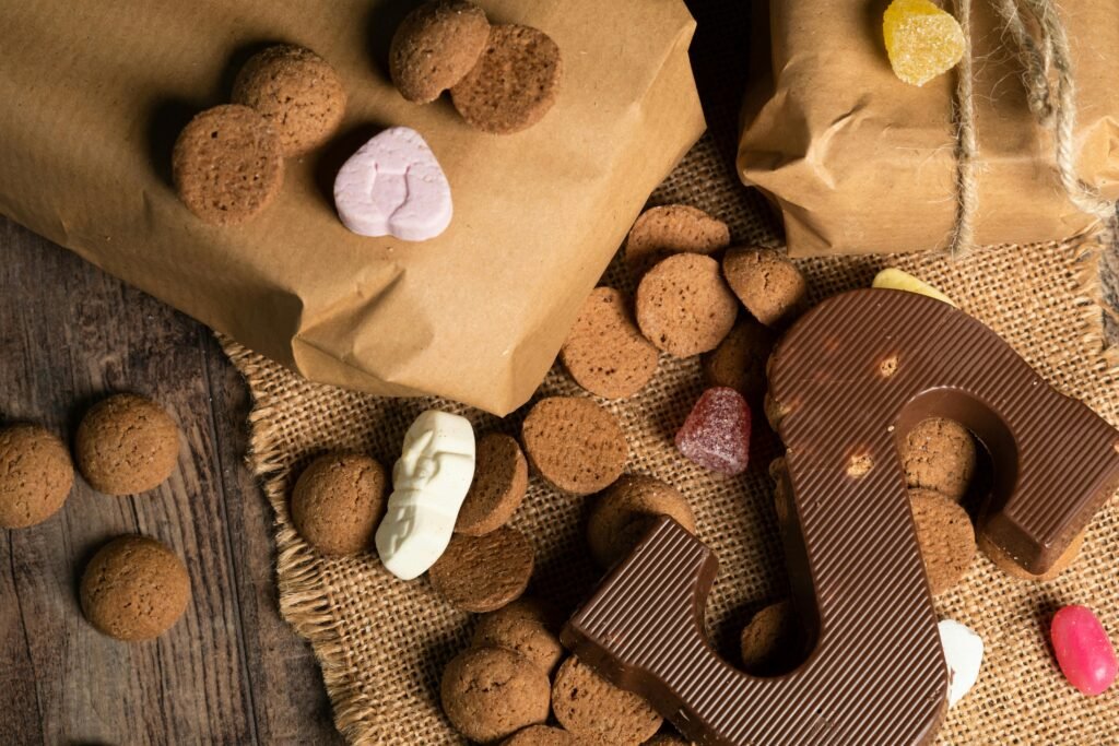 Close-up of a chocolate letter surrounded by ginger cookies and holiday candies.