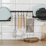 Airbnb Kitchen Mistakes That Frustrate Guests Elegant kitchen display featuring utensils, herbs, and dishware for a contemporary look.