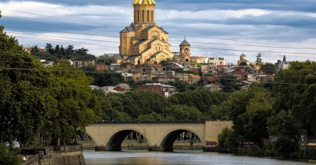 Scenic view of the Holy Trinity Cathedral and bridge over the Kura River in Tbilisi, Georgia.