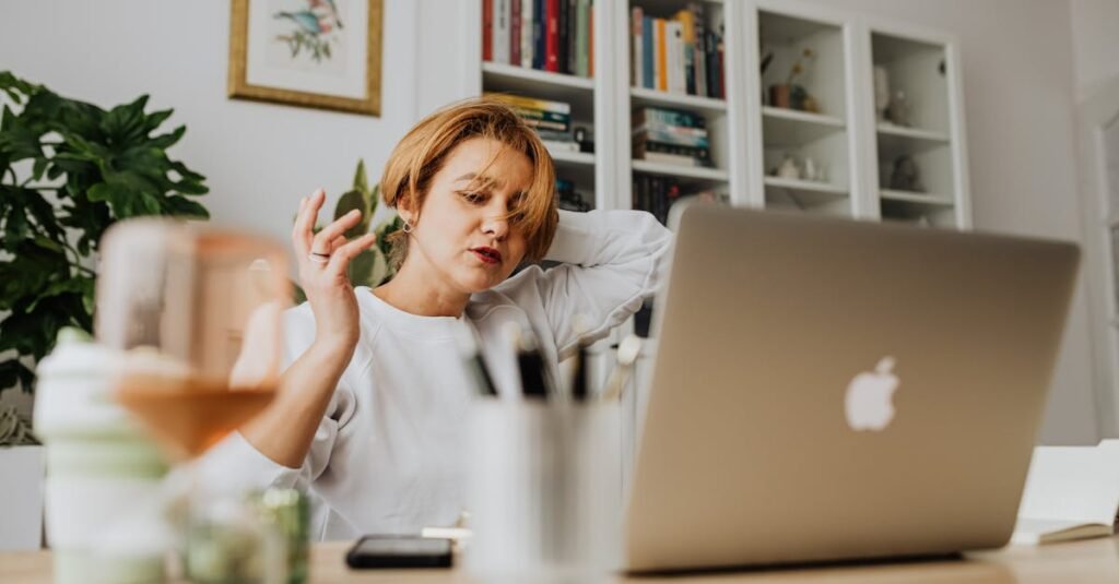 person stressed paperwork laptop