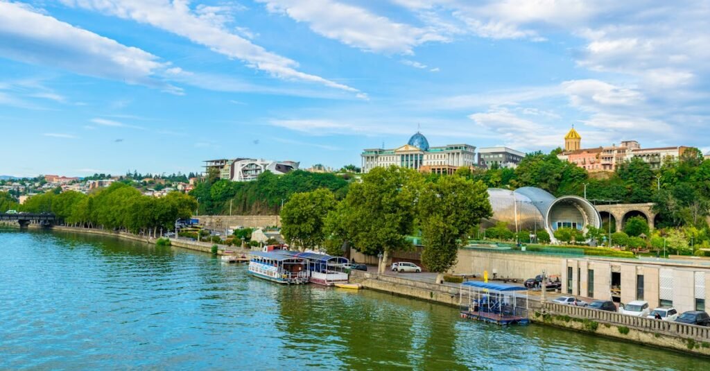 Beautiful riverside showing Tbilisi's vibrant urban architecture with ferries along the canal.